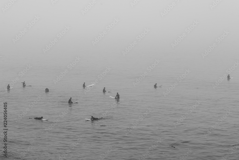 surfers in fog