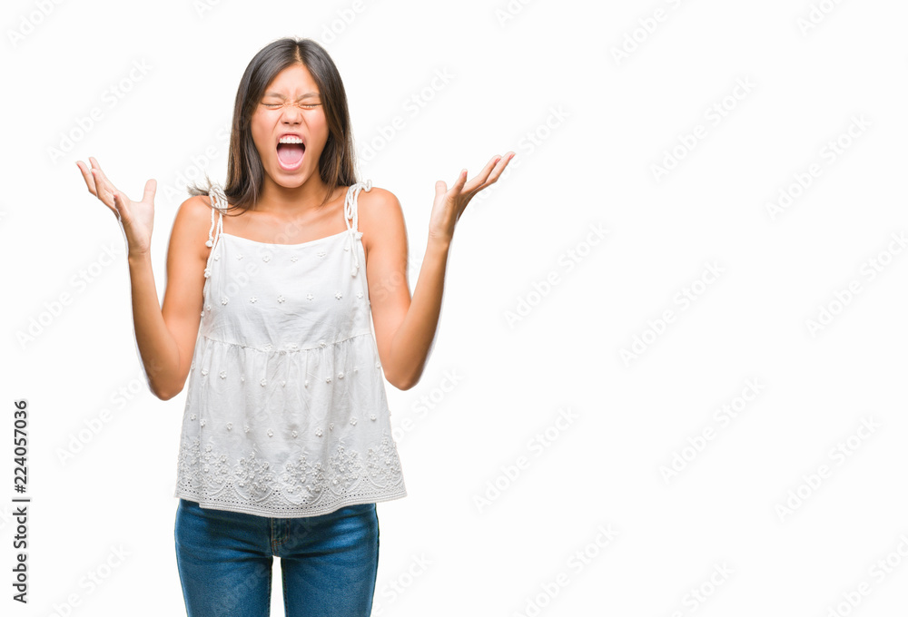 Young asian woman over isolated background crazy and mad shouting and yelling with aggressive expression and arms raised. Frustration concept. Young asian woman over isolated background crazy and mad shouting and yelling with aggressive expression and arms raised. Frustration concept.