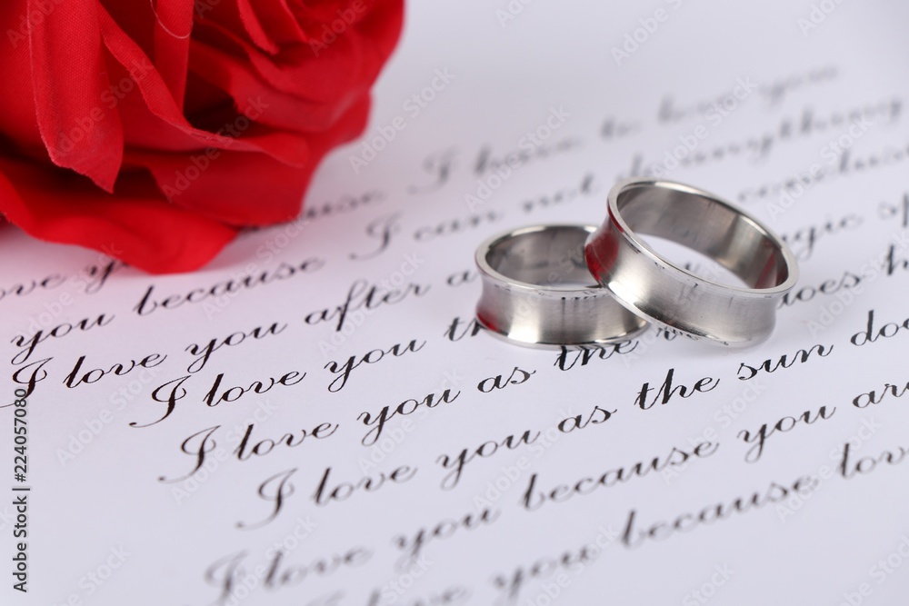 wedding rings - two silver wedding rings on a love letter - proposal of marriage wedding rings - two silver wedding rings on a love letter - proposal of marriage