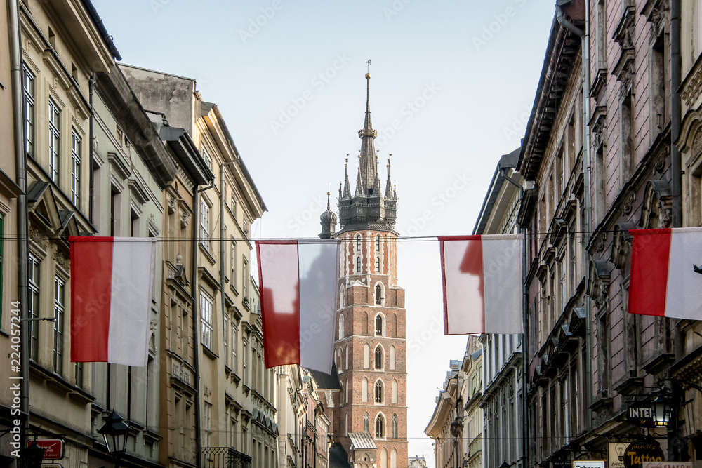 Flags on the Szczepańska street with the Basilica of Santa María in the background