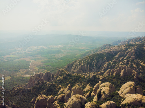 Montserrat, Catalonia, Spain. Top View Of Hillside Cave Santa Cova De Montserrat Or Holy Cave Of Montserrat In Summer Day. photo