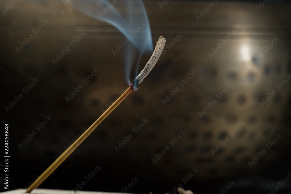 Singing bowl and incense sticks. The incense has almost burnt out Singing bowl and incense sticks. The incense has almost burnt out
