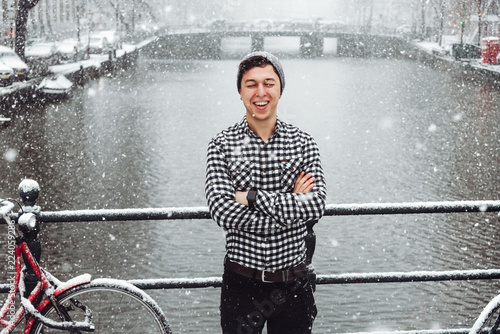 Guy is standing on a bridge