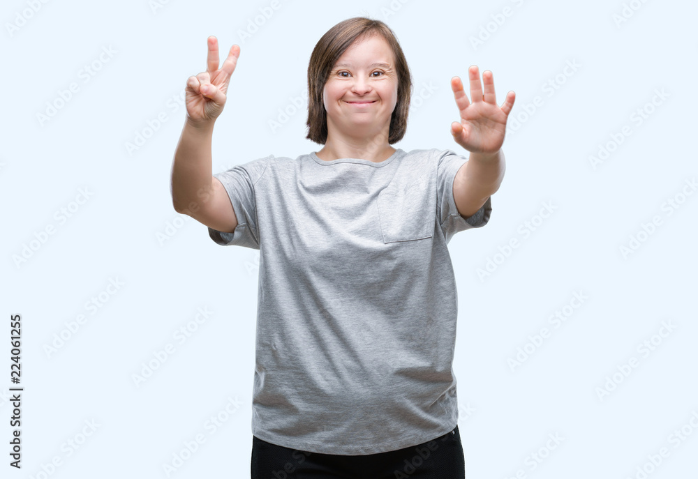 Young adult woman with down syndrome over isolated background showing and pointing up with fingers number seven while smiling confident and happy. Young adult woman with down syndrome over isolated background showing and pointing up with fingers number seven while smiling confident and happy.