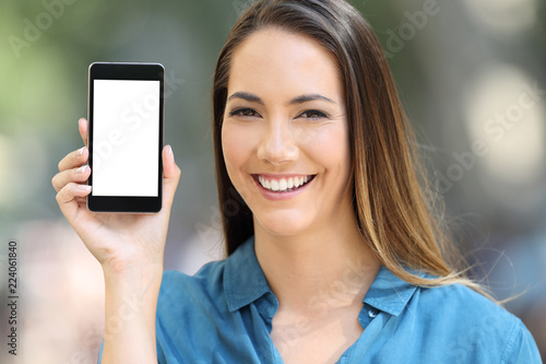 Girl looking at camera showing a smart phone screen