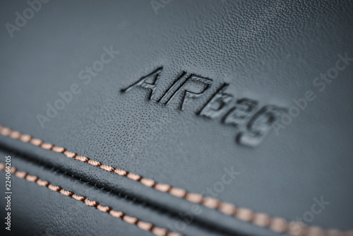 Detailed image of a dashboard airbag zone leather stitch work. photo