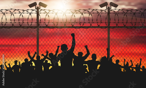 Enraged crowd of people are behind bars. Fence wire mesh barbed wire, vector silhouette. Street camera on the pillar. Sunset background. (Clipping Mask)