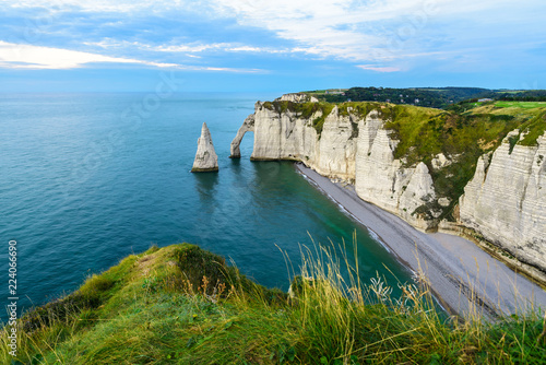 cliffs Aval and Needle of Etretat and beautiful famous coastline during the tide. Normandy, France