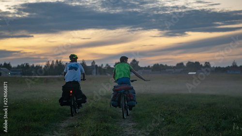 Bicyclists in the foggy field in Russia