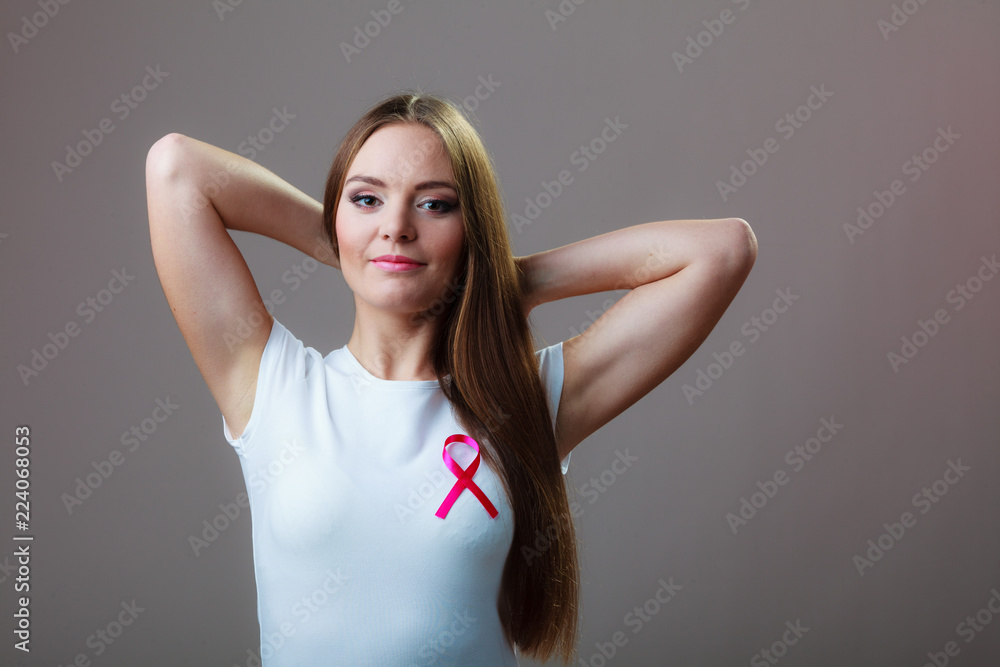 Woman wih pink cancer ribbon on chest