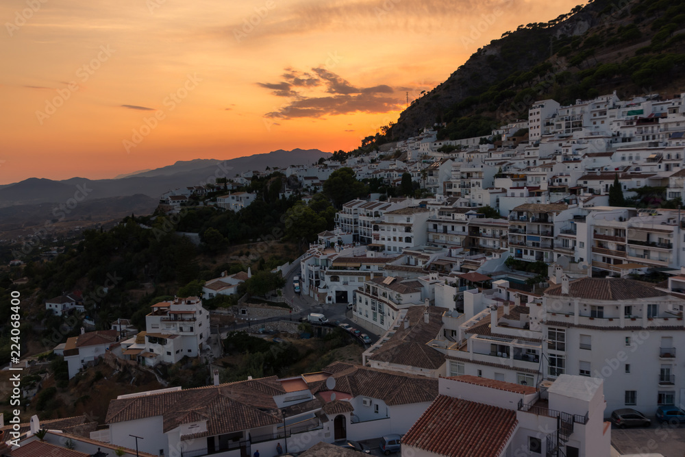 Panorama of an Andalusian white village with sunset behind the mountain (Mijas, Spain)