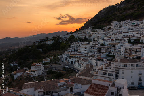 Panorama of an Andalusian white village with sunset behind the mountain (Mijas, Spain)