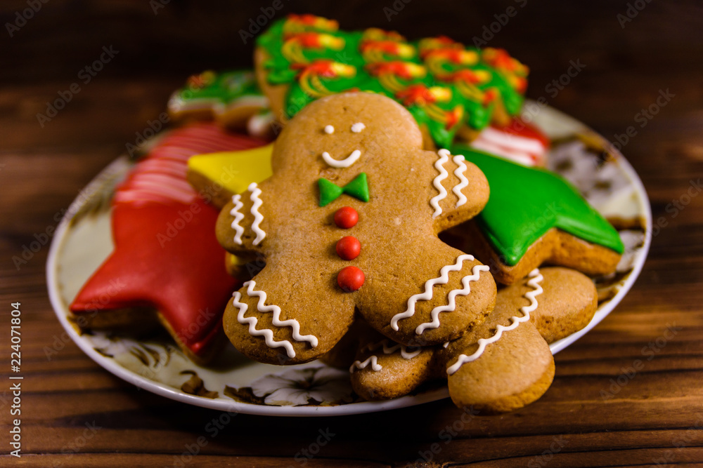 Plate with different christmas gingerbread cookies on wooden table Plate with different christmas gingerbread cookies on wooden table