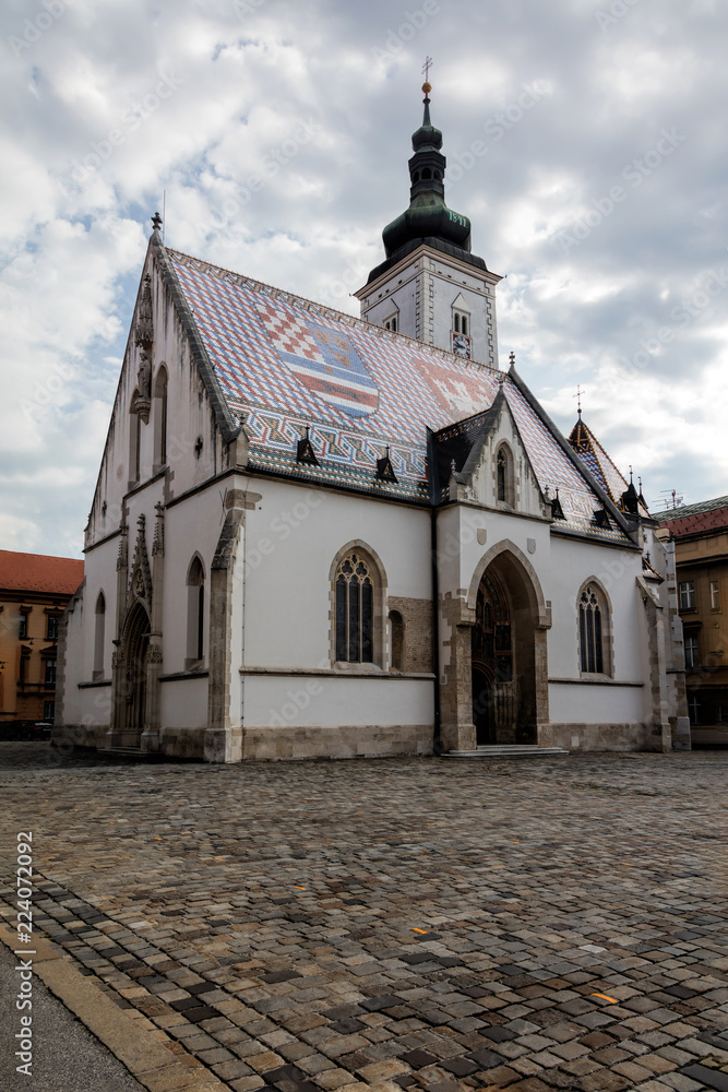 Obraz premium The Church of St. Mark, located in St. Mark's Square in Zagreb, Croatia, originated in the 13th century, reconstructed in the 14th century, featured the Zagreb Coat of arms on the roof.