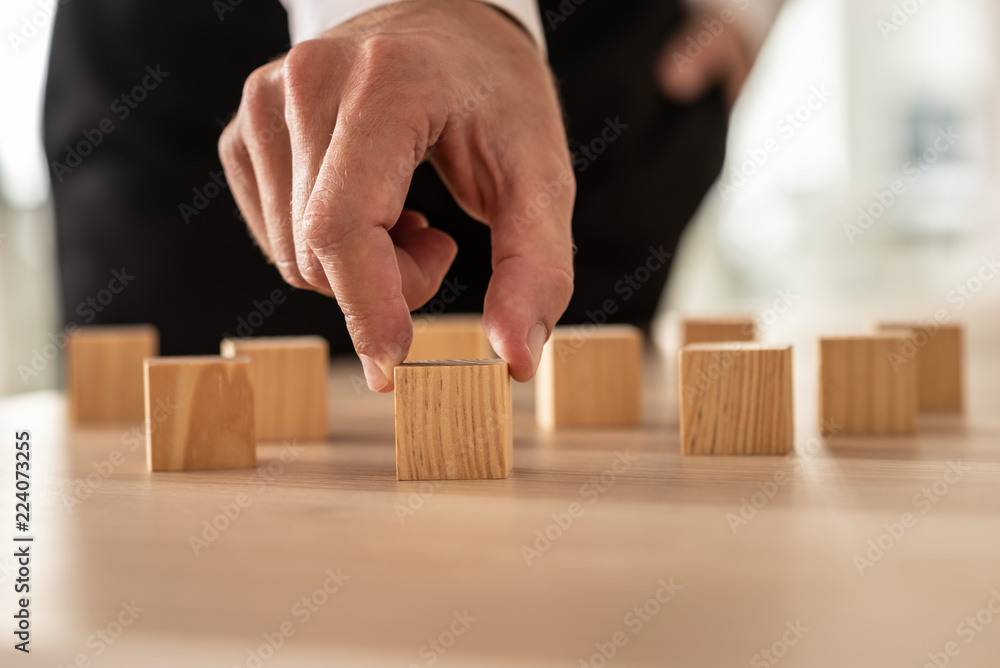 Conceptual Businessman Holding Empty Wooden Cube Conceptual Businessman Holding Empty Wooden Cube