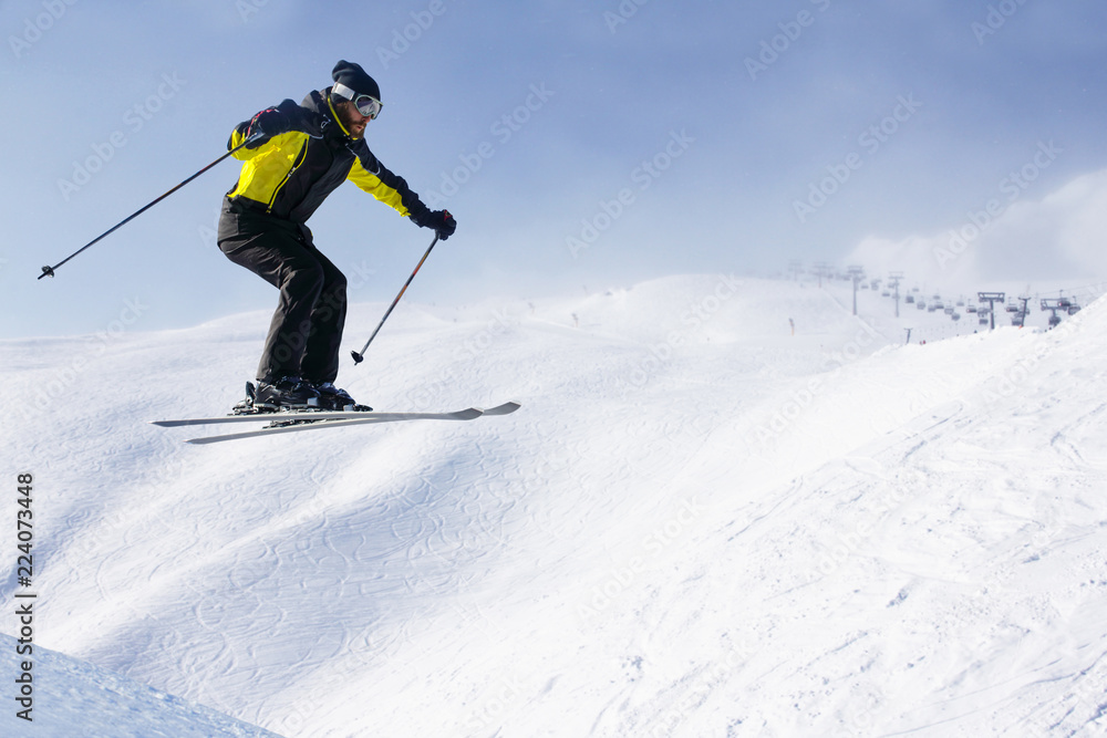 Jumping skier at mountains