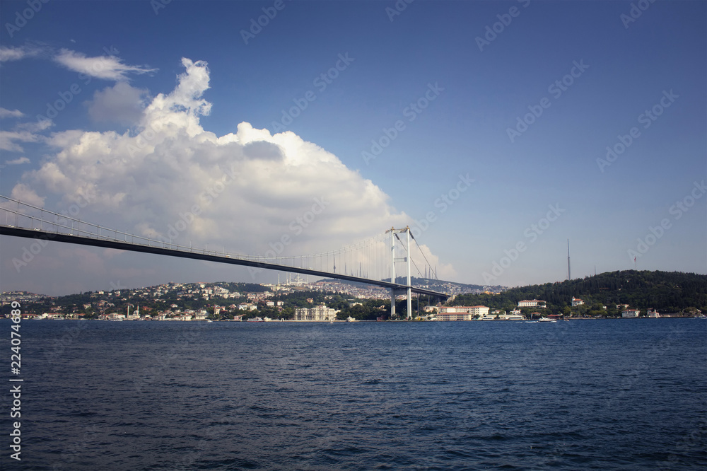 View of Bosphorus bridge with cloudy sky background and Asian side in a sunny summer day in Istanbul.