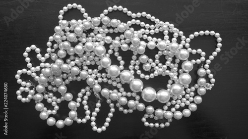 Shimmering pearl necklaces isolated on black background. Close-up