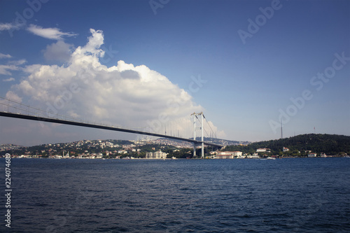View of Bosphorus bridge with cloudy sky background and Asian side in a sunny summer day in Istanbul. © theendup