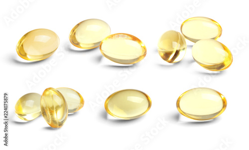 Set with cod liver oil pills on white background