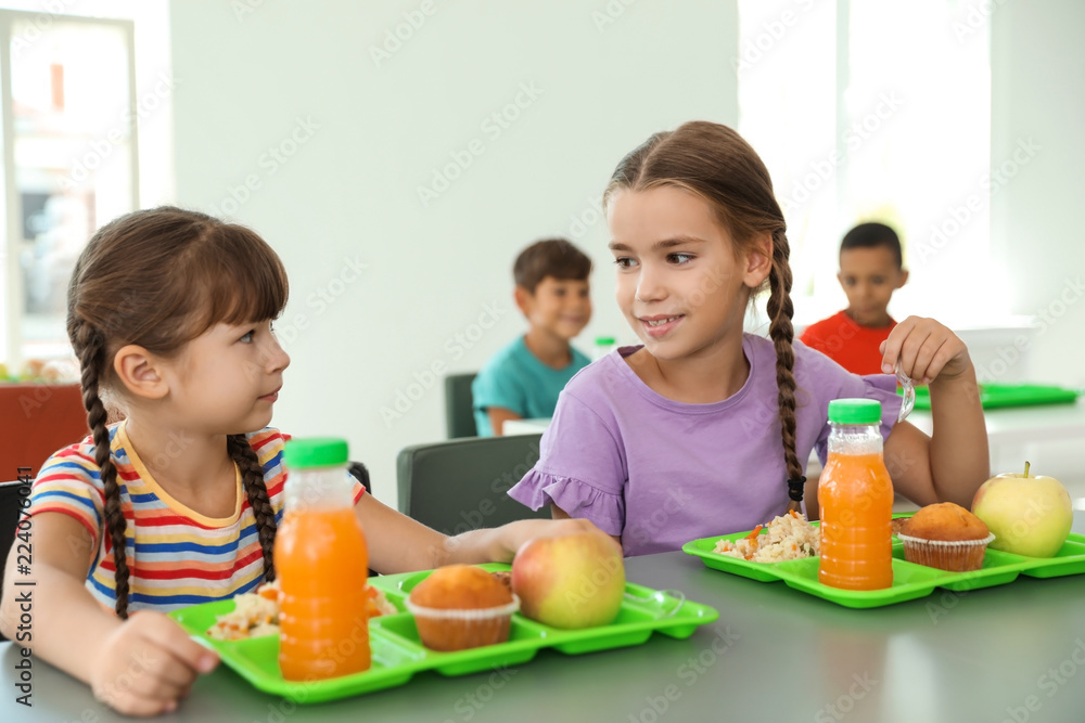 Children sitting at table and eating healthy food during break at school Children sitting at table and eating healthy food during break at school