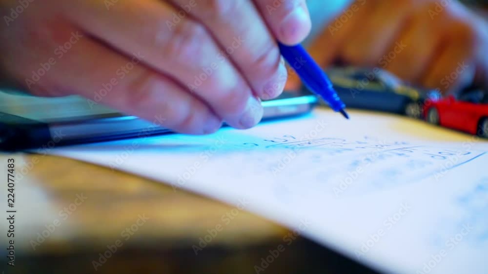 man's hand writes on paper with a pen.closeup.business concept.Blurred image. Focus on the pen.model of a toy car and an electronic device on a desk.sale, purchase or insurance of a car.
man's hand writes on paper with a pen.closeup.business concept.Blurred image. Focus on the pen.model of a toy car and an electronic device on a desk.sale, purchase or insurance of a car.
