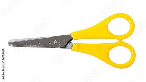 Yellow scissors with ruler isolated on white background photo