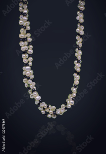 black and white pearls necklace in a black background 