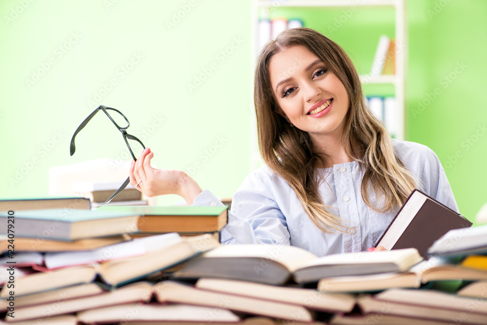 Young female student preparing for exams with many books Young female student preparing for exams with many books