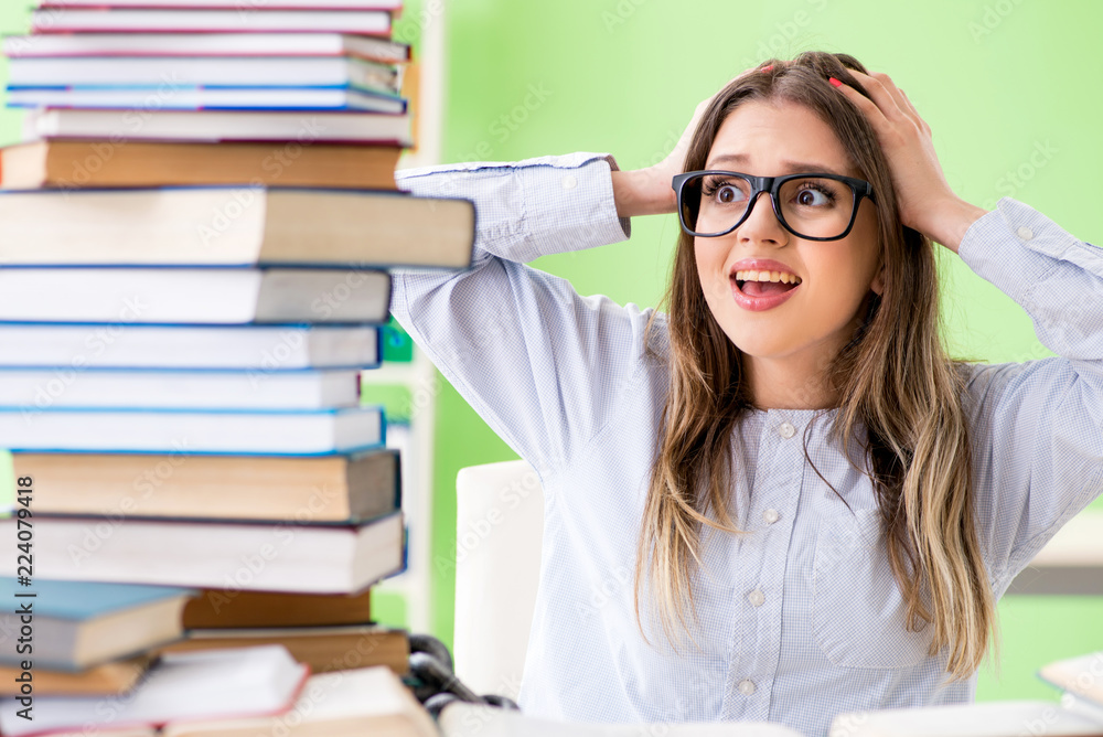 Young female student preparing for exams with many books Young female student preparing for exams with many books