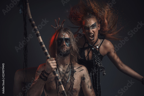 Dark shaman or tribal warlock summoning a succubus demon, screaming witch or other spirit; halloween concept photo