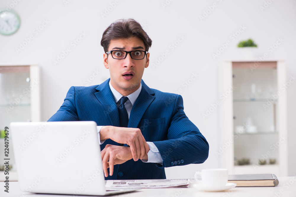 Young handsome employee siitting at office Young handsome employee siitting at office
