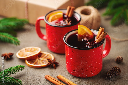 Konstfotografi Two cups of christmas mulled wine or gluhwein with spices and orange slices on rustic table top view