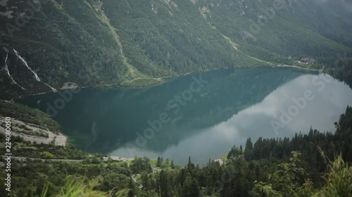 Charming beautiful blue mountain lake with green forest and high mountains in the background Morskie Oko - Poland europe hill landscape nature peak rock sky tatra close up slow motion