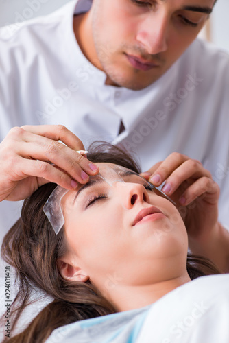 Doctor measuring patient's face before plastic surgery