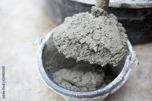 Cement or mortar, Cement powder with a trowel put on the brick at construction work.