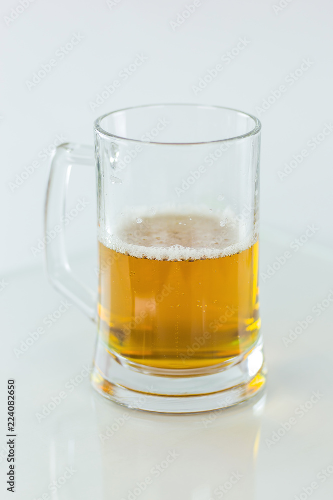 Beer glass half full on white background Beer glass half full on white background