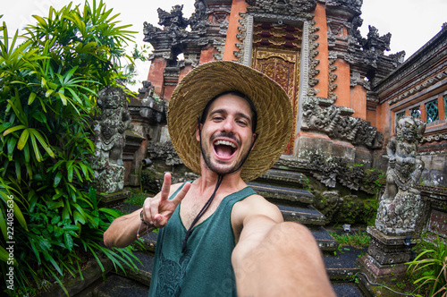 Handsome man taking a selfie on a trip in Asia