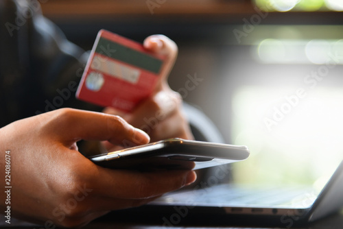 Online payment,woman's hands holding credit card and using laptop computer for online shopping. Cyber Monday Concept