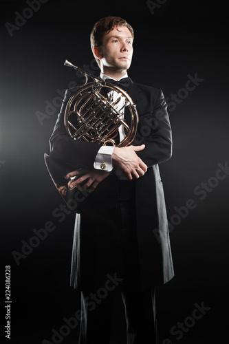 Portrait of classic musician with french horn