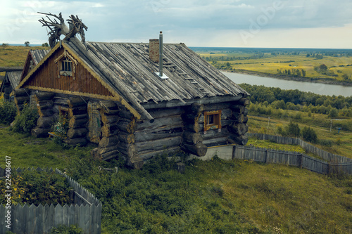 Wallpaper Mural Chopped hut from oak logs on the river bank Torontodigital.ca