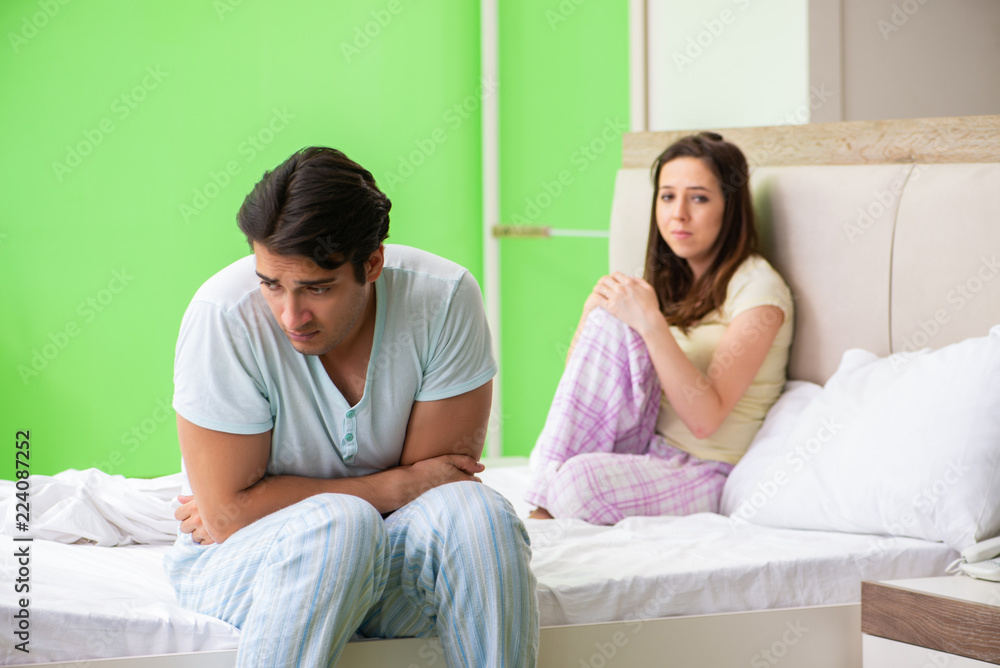 Woman and man in the bedroom after conflict Woman and man in the bedroom after conflict