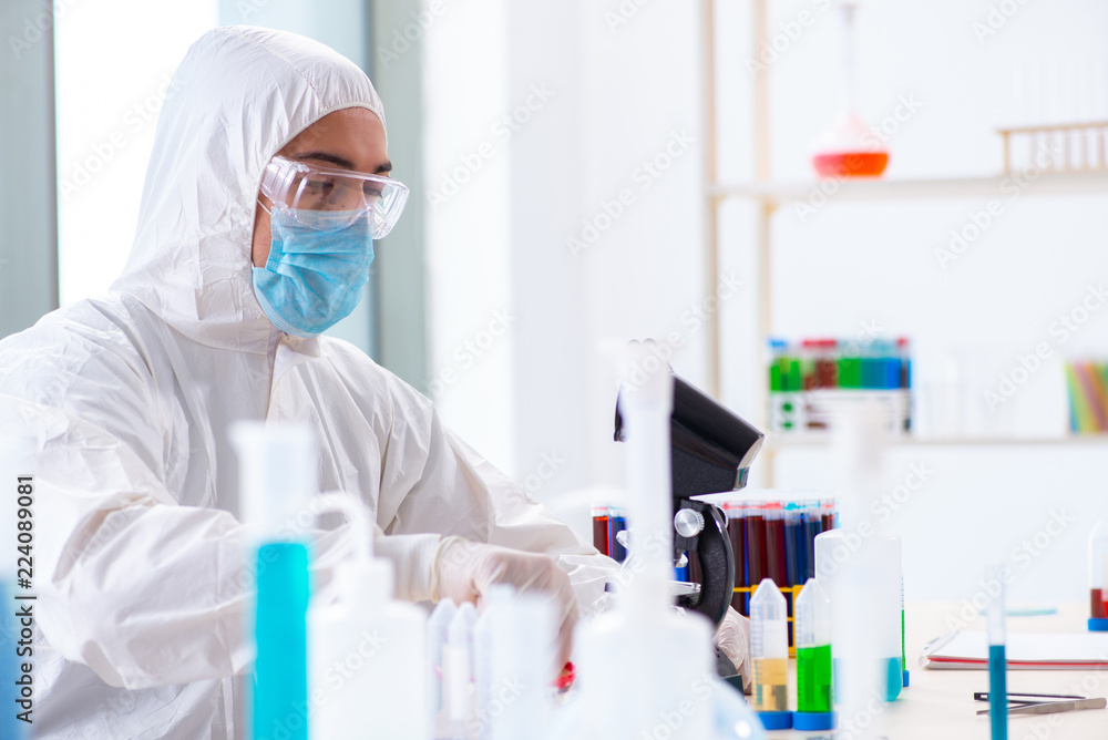 Young chemist student working in lab on chemicals Young chemist student working in lab on chemicals