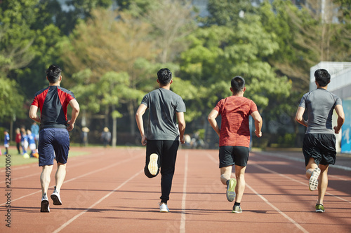 young asian athletes running on track © imtmphoto