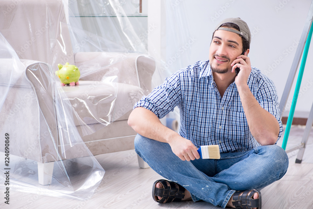 Young painter doing renovation at home Young painter doing renovation at home