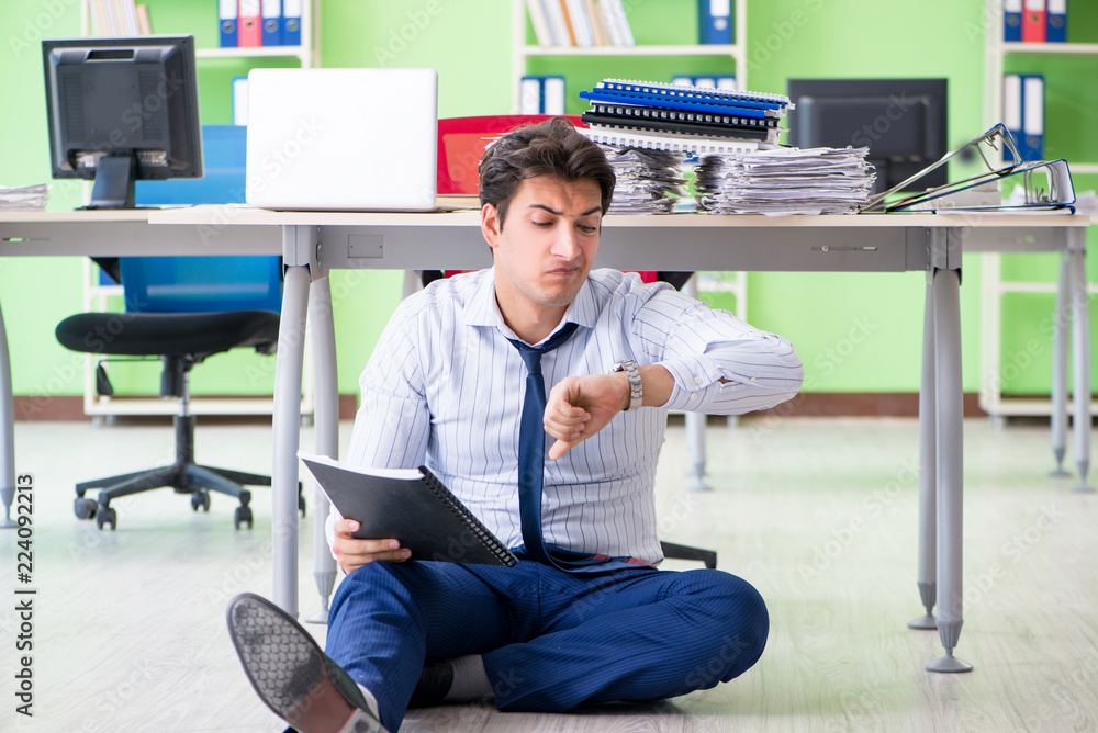 Frustrated businessman stressed from excessive work Frustrated businessman stressed from excessive work