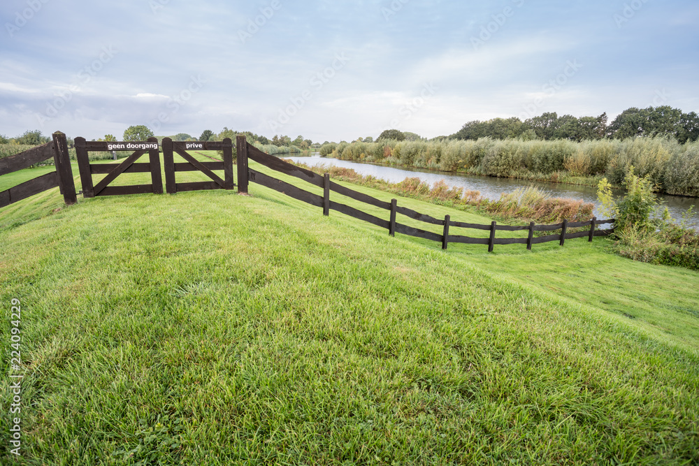 Grass field with wooden fence