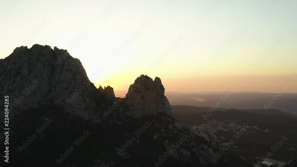 Video from above, aerial view oa a spectacular sunset behind some granite mountains. San Pantaleo village in the background, Sardinia, Italy. Video from above, aerial view oa a spectacular sunset behind some granite mountains. San Pantaleo village in the background, Sardinia, Italy.