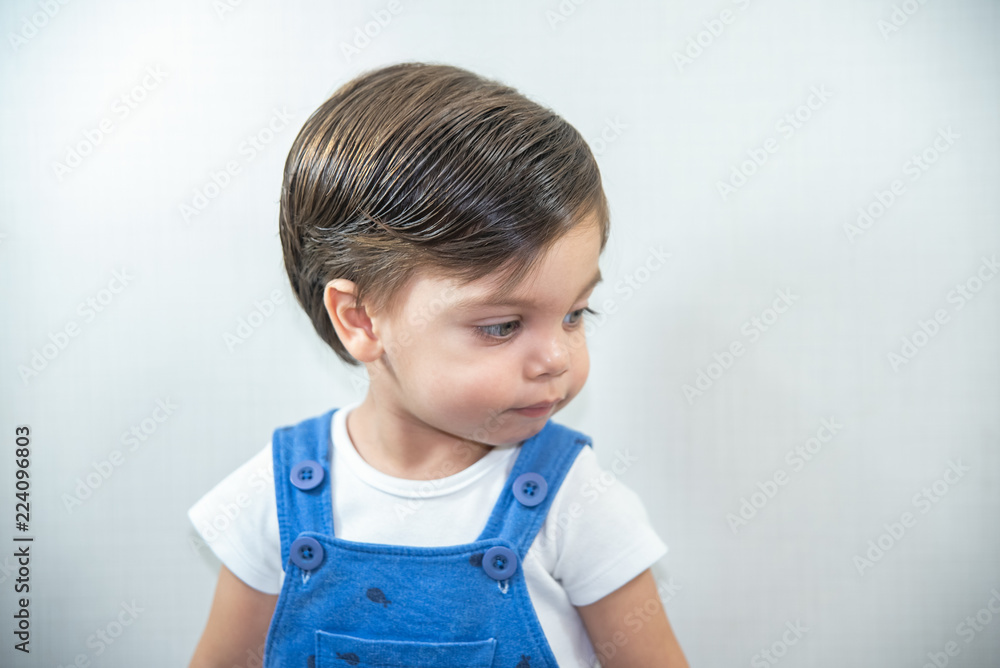 Cute baby boy toddler - with blue romper on white background Cute baby boy toddler - with blue romper on white background