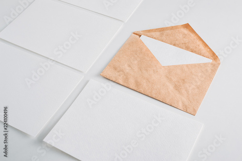 White paper empty sheets cards and kraft envelope on a white background. Mockup for design